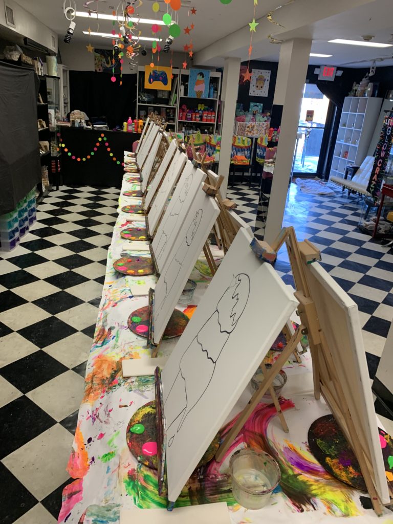 A table covered with several charts displaying a variety of art designs